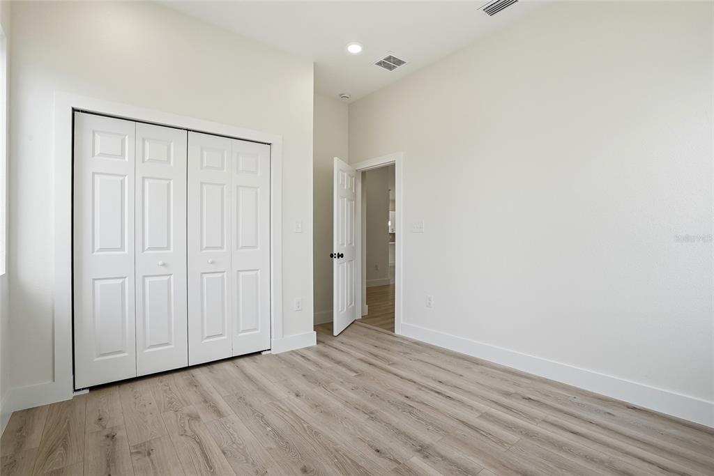 11256 Salters Street Spring Hill, FL 34609 - Photo 25 of 46 a view of an empty room with wooden floor