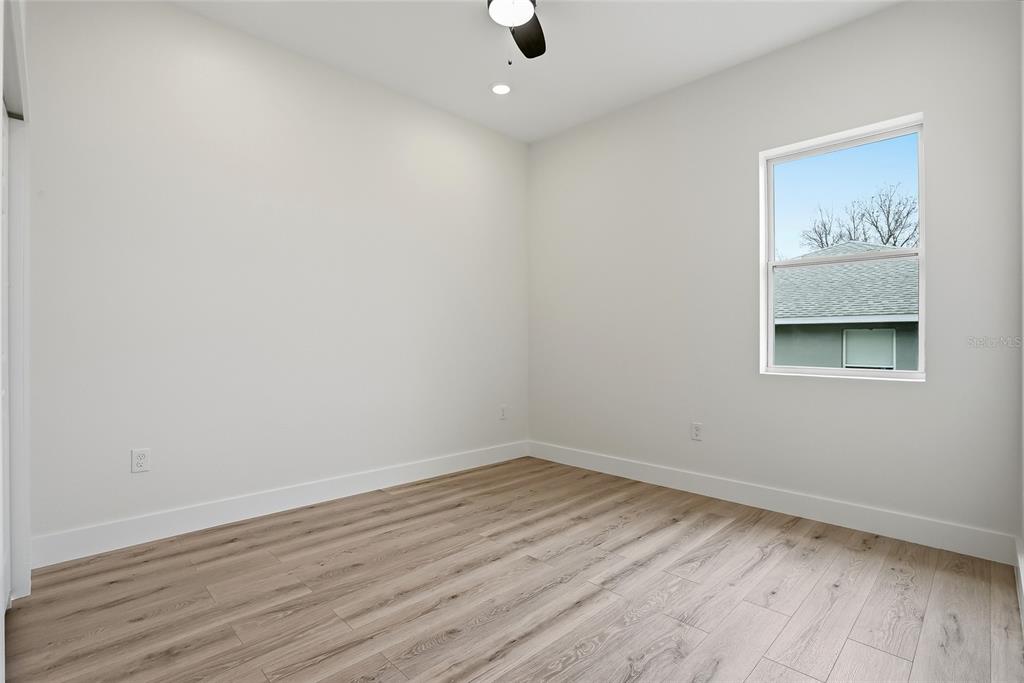 11256 Salters Street Spring Hill, FL 34609 - Photo 28 of 46 wooden floor in an empty room with a workspace