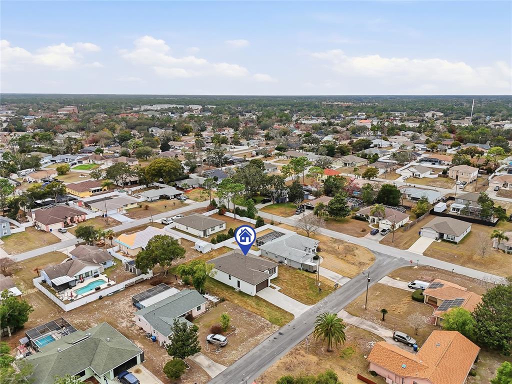 11256 Salters Street Spring Hill, FL 34609 - Photo 44 of 46 an aerial view of a city with lots of residential buildings and mountain view in back