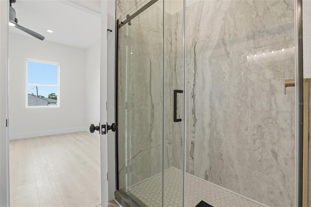 11256 Salters Street Spring Hill, FL 34609 - Photo 7 of 46 a bathroom with a shower