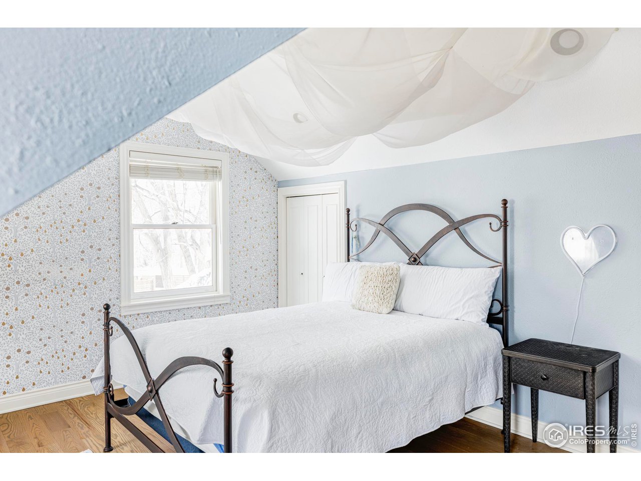 2485 Agate Lane Boulder, CO 80304 - Photo 25 of 38 a bedroom with a bed next to a window with outer view and chair