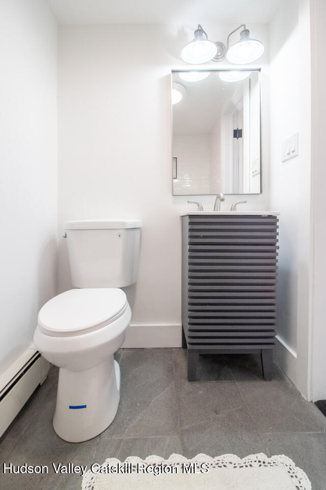 10 State Rte 55 Napanoch, NY 12458 - Photo 31 of 42 a bathroom with a toilet a sink and mirror