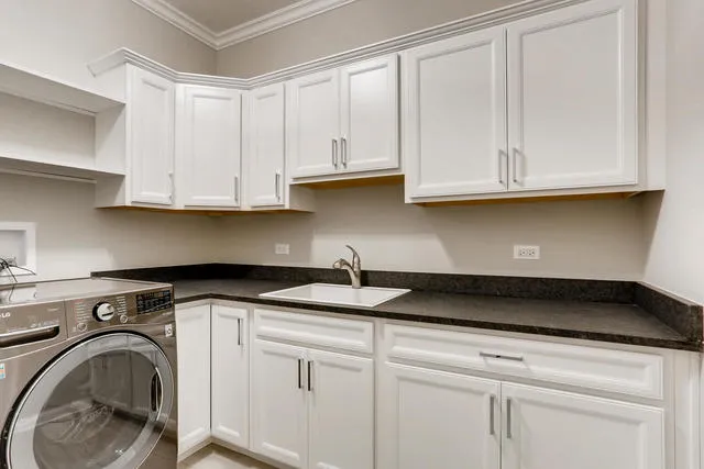 a kitchen with granite countertop white cabinets and a sink