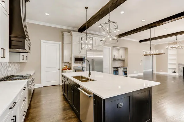 a kitchen with a stove a refrigerator a sink dishwasher with wooden floor and cabinets