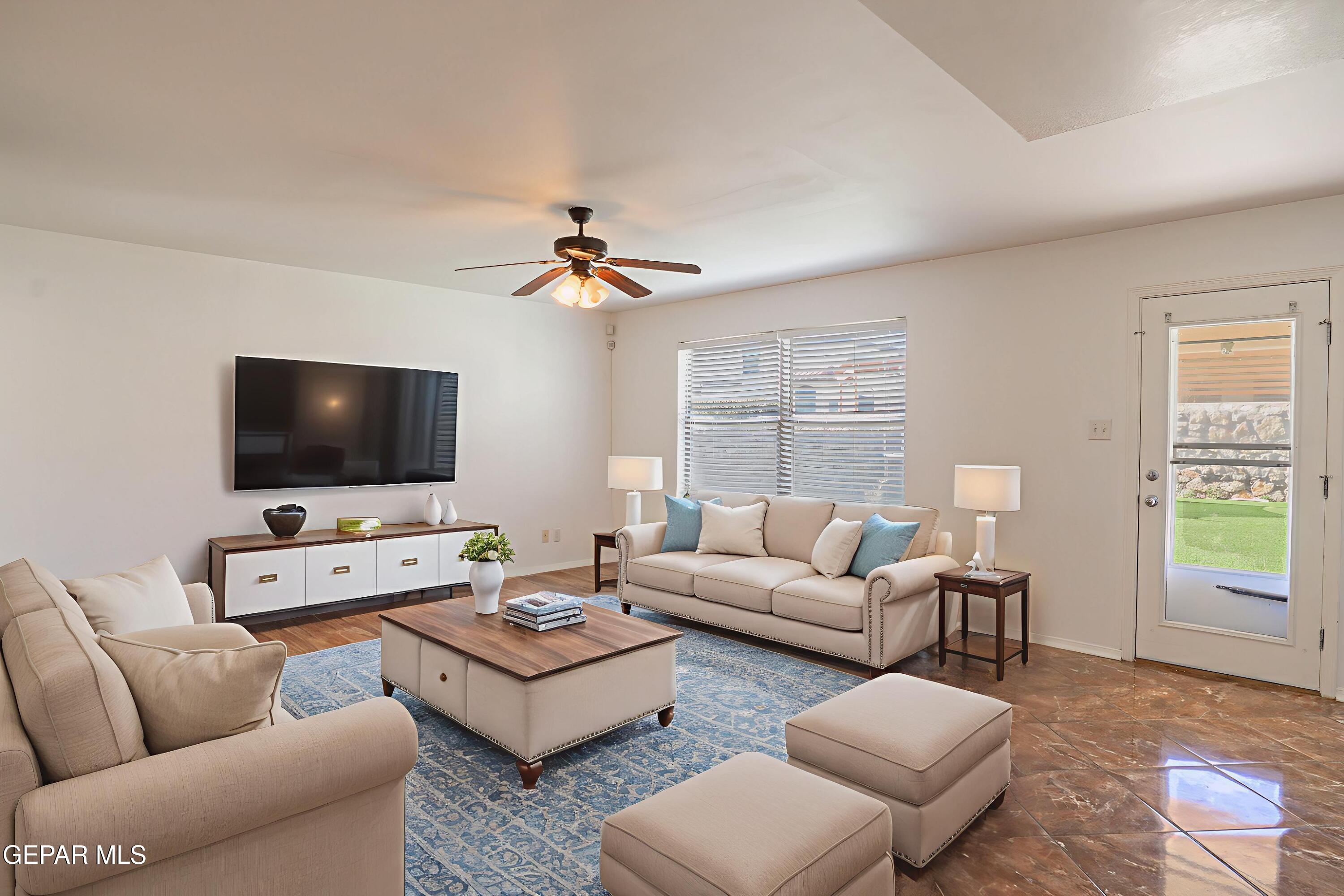 1497 Dunlin Place El Paso, TX 79928 - Photo 14 of 38 a living room with furniture and a flat screen tv