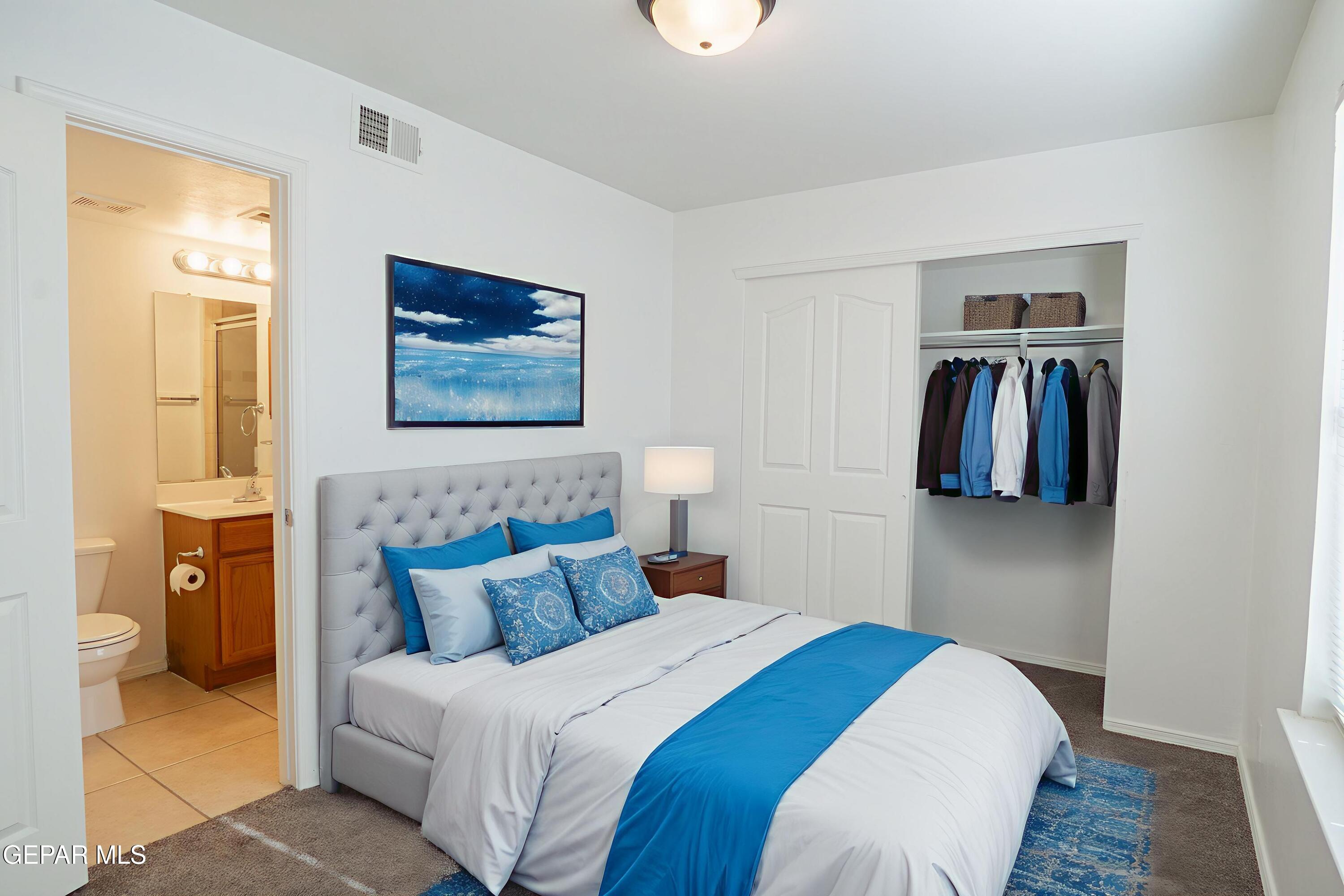 1497 Dunlin Place El Paso, TX 79928 - Photo 16 of 38 a bedroom with a bed and painting on the wall