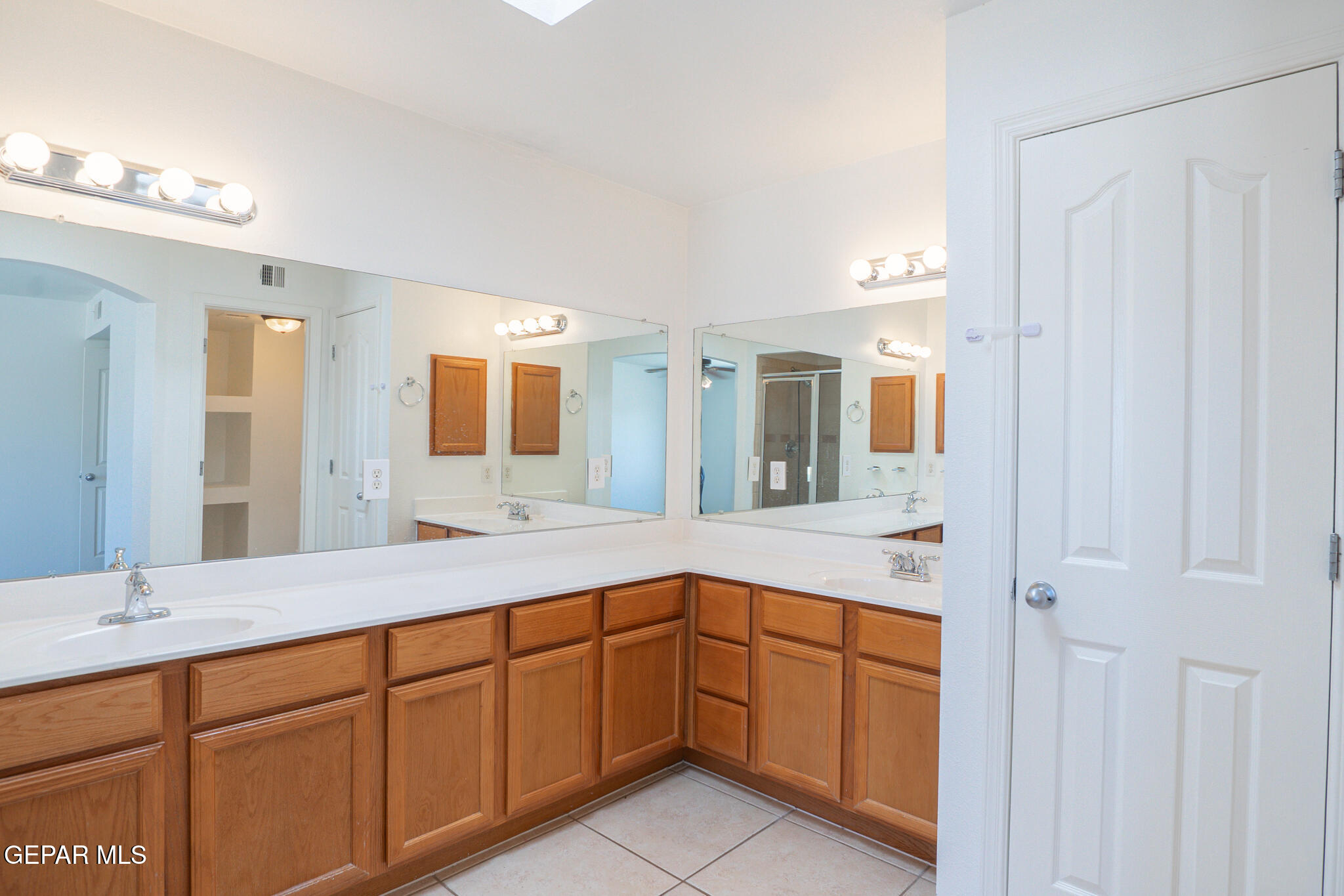 1497 Dunlin Place El Paso, TX 79928 - Photo 22 of 38 a spacious bathroom with a double vanity sink and a mirror