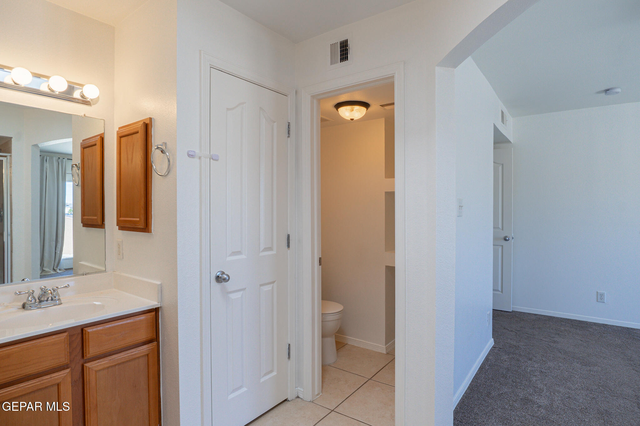 1497 Dunlin Place El Paso, TX 79928 - Photo 23 of 38 a bathroom with a sink and a mirror