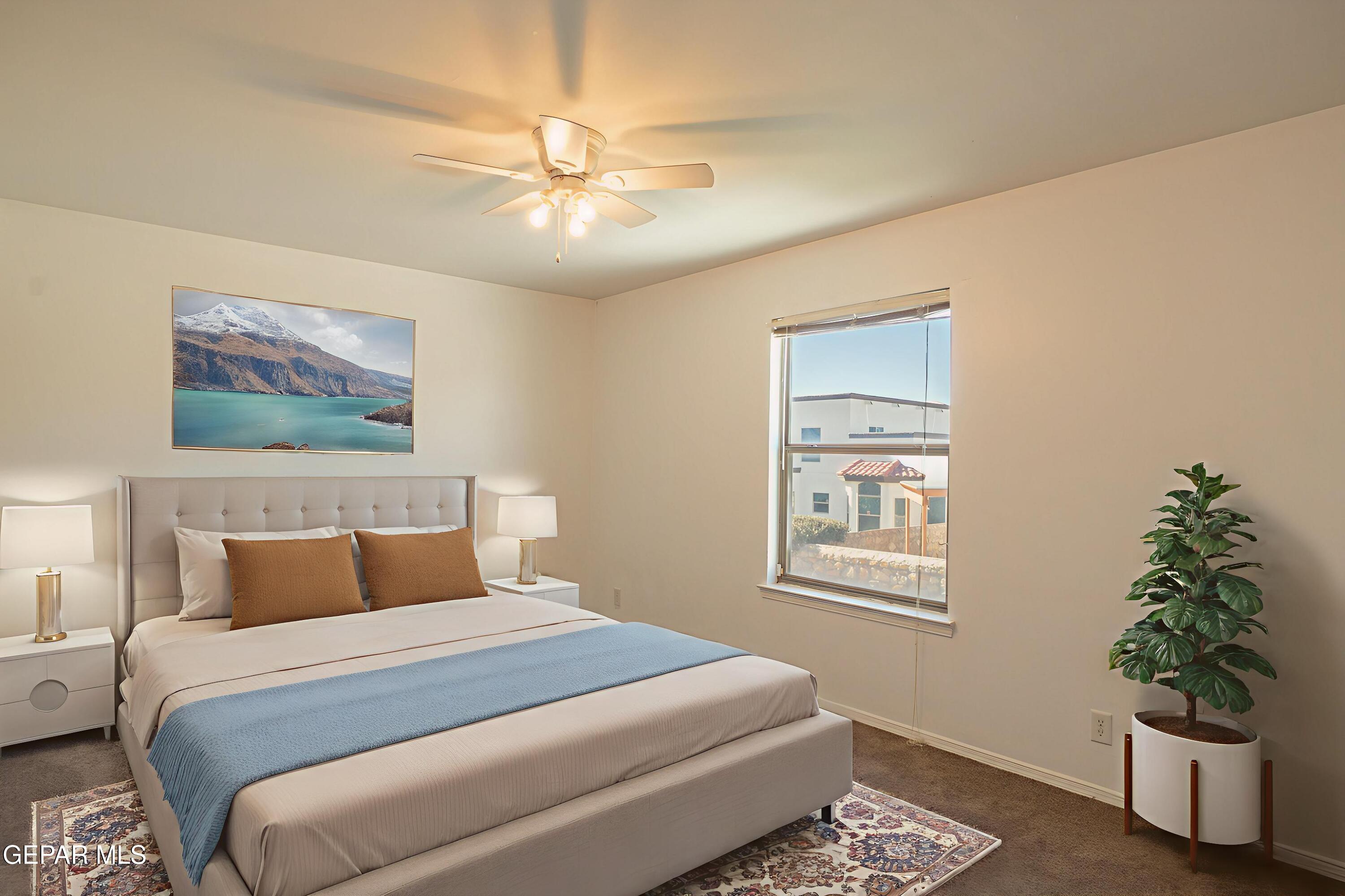 1497 Dunlin Place El Paso, TX 79928 - Photo 30 of 38 a bedroom with a large bed and a chandelier