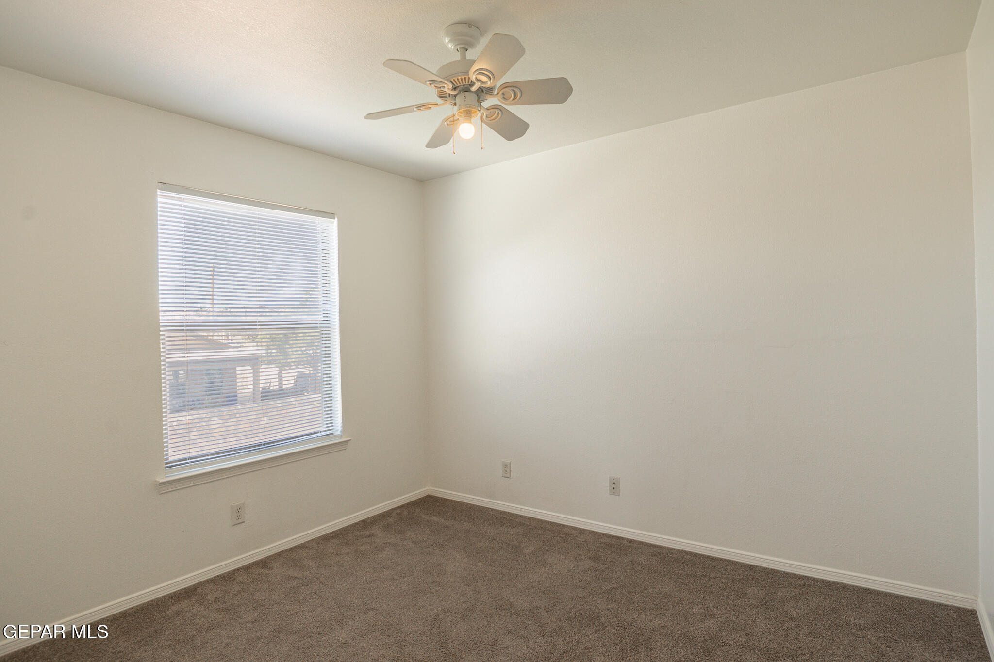 1497 Dunlin Place El Paso, TX 79928 - Photo 32 of 38 an empty room with windows and fan