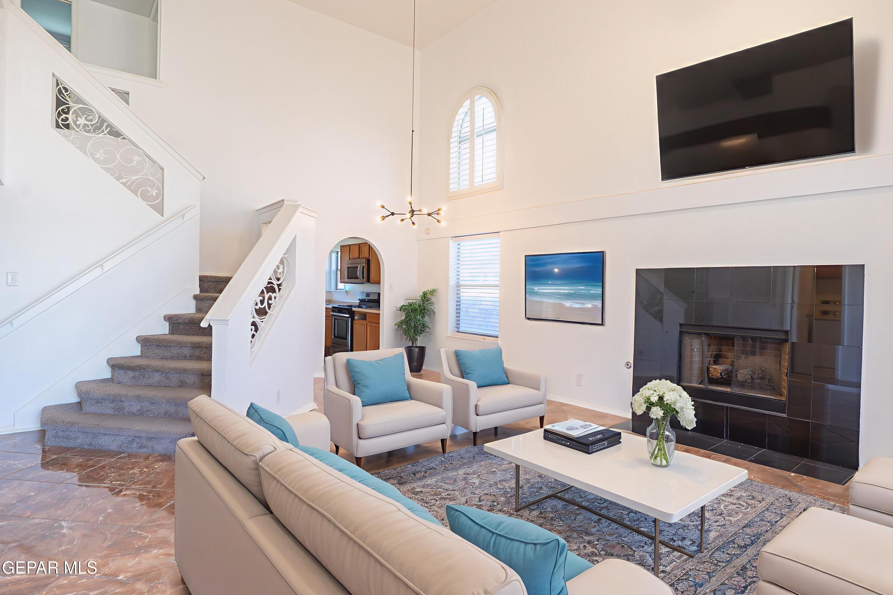 1497 Dunlin Place El Paso, TX 79928 - Photo 4 of 38 a living room with furniture fireplace and flat screen tv