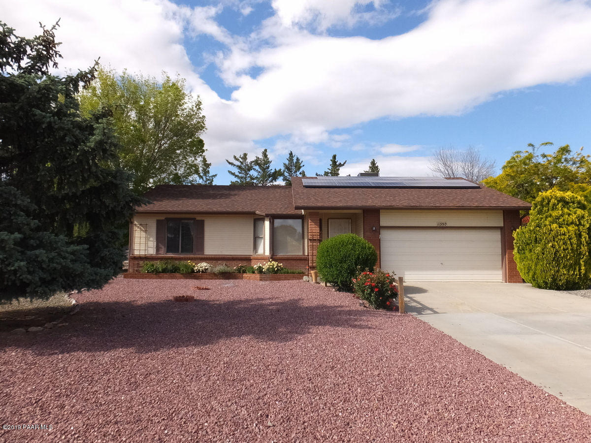 11950 Rawhide Ridge Dewey, AZ 86327 - Photo 1 of 37 a front view of a house with a yard and garage