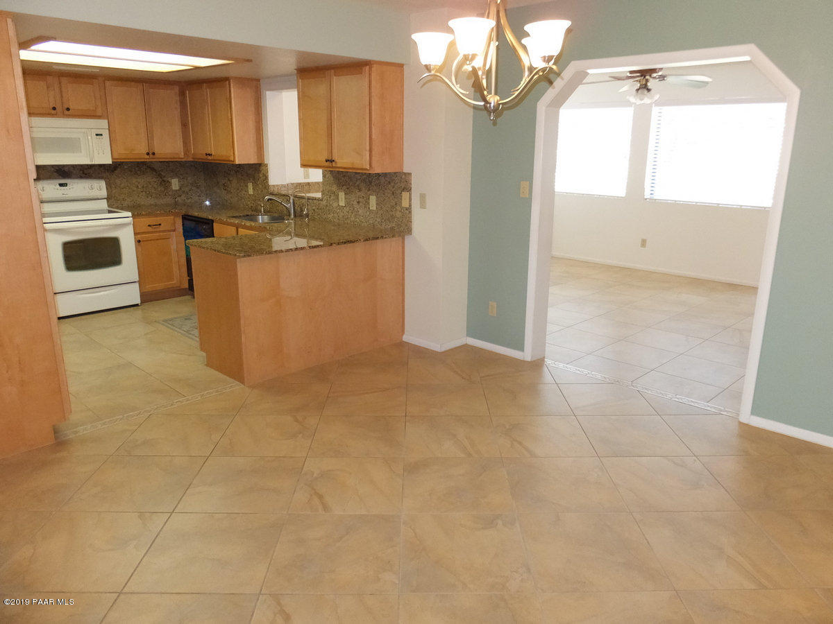 11950 Rawhide Ridge Dewey, AZ 86327 - Photo 8 of 37 a kitchen with stainless steel appliances granite countertop a sink and cabinets