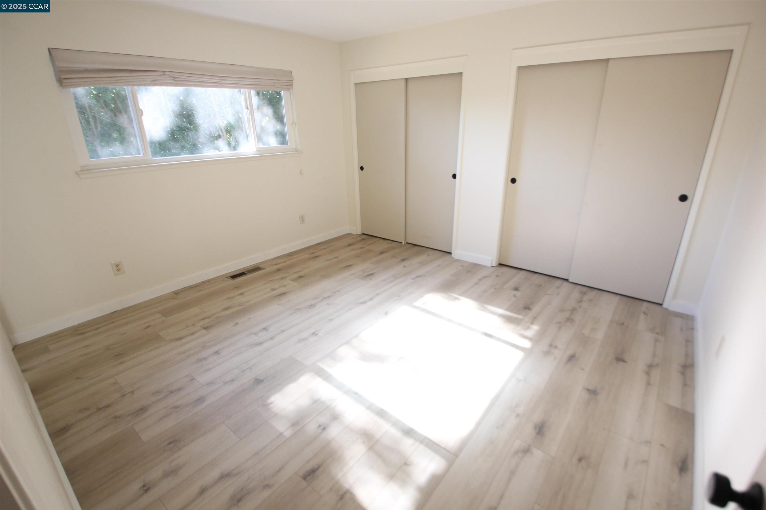 10 School Street Isleton, CA 95641 - Photo 12 of 23 a view of empty room with wooden floor and fan