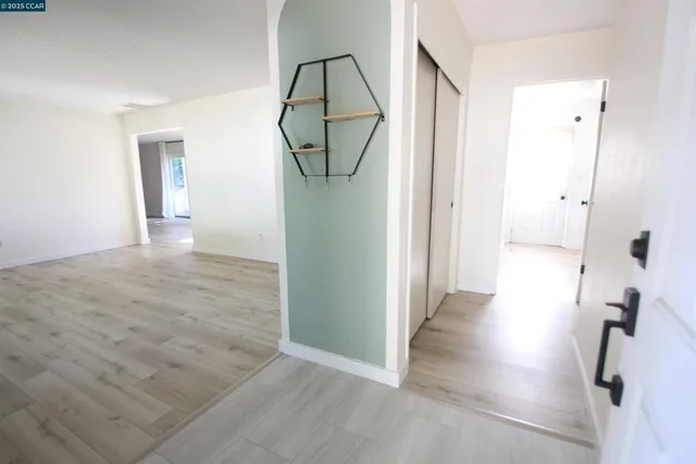 wooden floor with view of bathroom