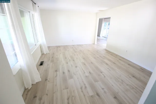 a view of a room with wooden floor