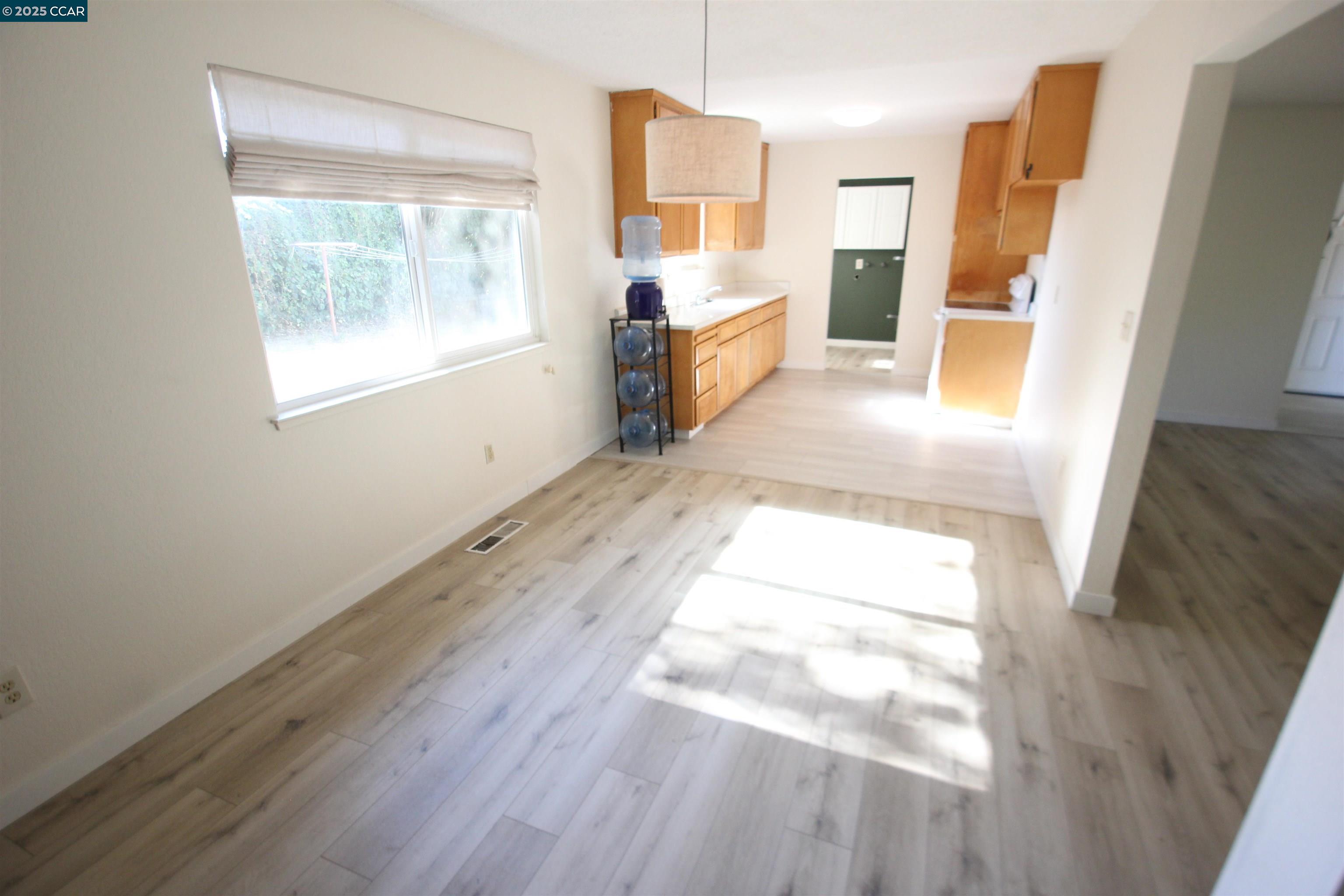 10 School Street Isleton, CA 95641 - Photo 5 of 23 a view of an empty room with wooden floor and a window