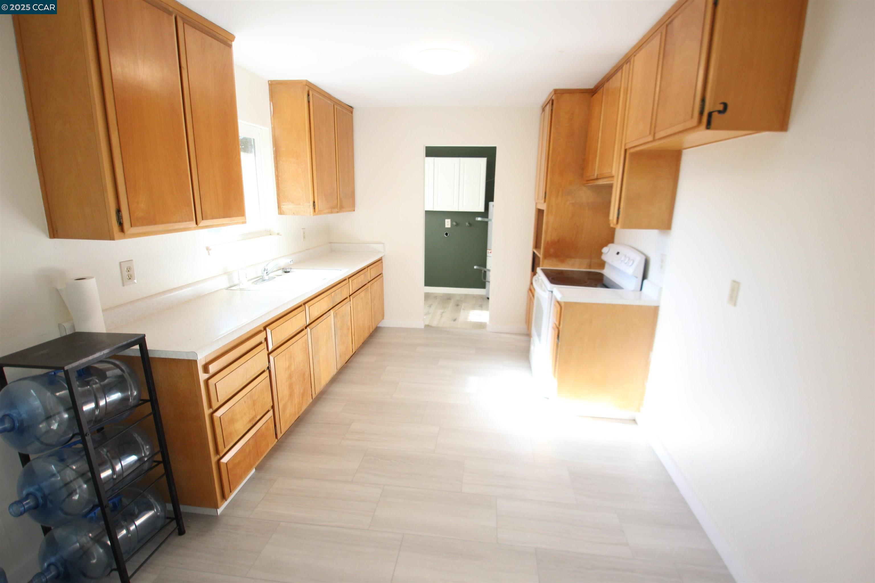 10 School Street Isleton, CA 95641 - Photo 6 of 23 a kitchen with stainless steel appliances a sink a stove and a refrigerator
