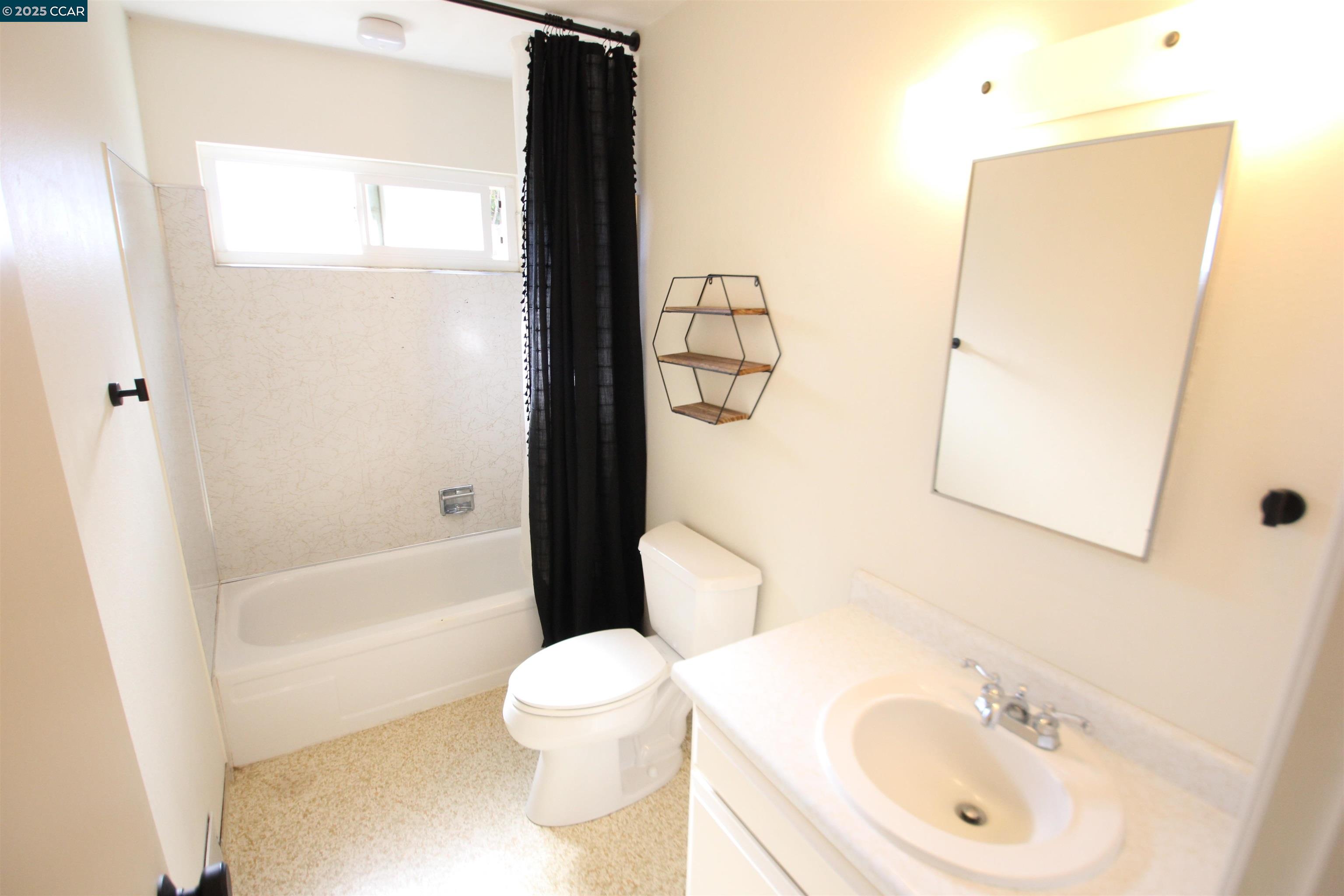 10 School Street Isleton, CA 95641 - Photo 8 of 23 a white toilet sitting next to a bathroom sink