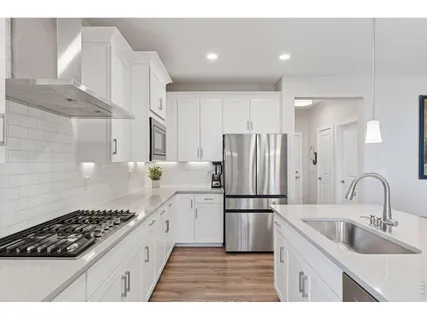 a kitchen with refrigerator a sink and cabinets