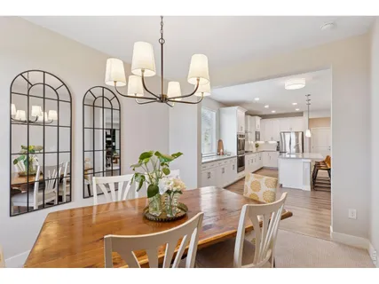 a dining room with furniture and wooden floor