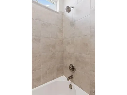 a bathroom with a bathtub and shower