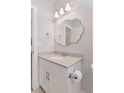 a bathroom with a sink a mirror and a light fixture
