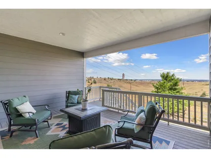 a view of a patio with a dining table and chairs with wooden floor