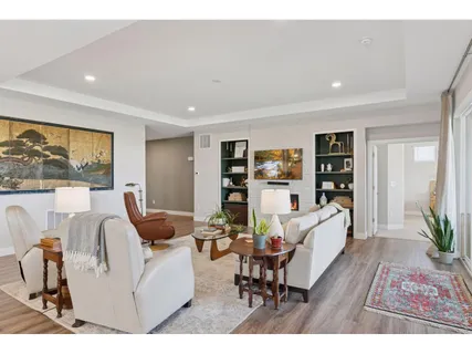 a living room with furniture and a wooden floor