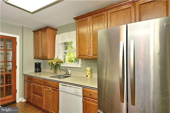 9503 St Andrews Way Silver Spring, MD 20901 - Photo 14 of 30 a kitchen with stainless steel appliances granite countertop a refrigerator and a sink