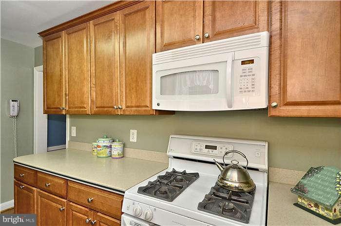 9503 St Andrews Way Silver Spring, MD 20901 - Photo 15 of 30 a kitchen with a stove and a microwave