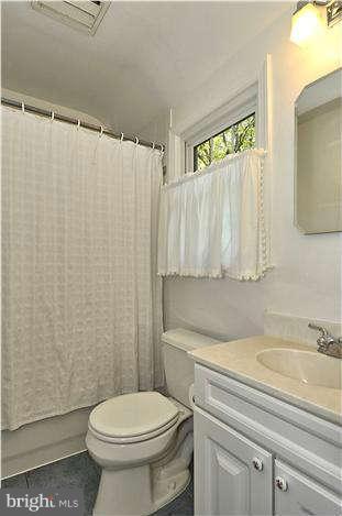 9503 St Andrews Way Silver Spring, MD 20901 - Photo 22 of 30 a bathroom with a sink a toilet and a mirror