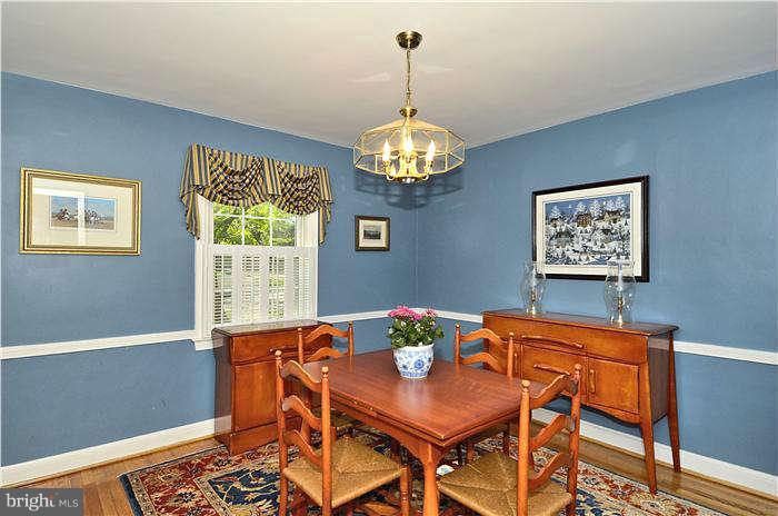 9503 St Andrews Way Silver Spring, MD 20901 - Photo 8 of 30 a view of a dining room with furniture a chandelier and wooden floor