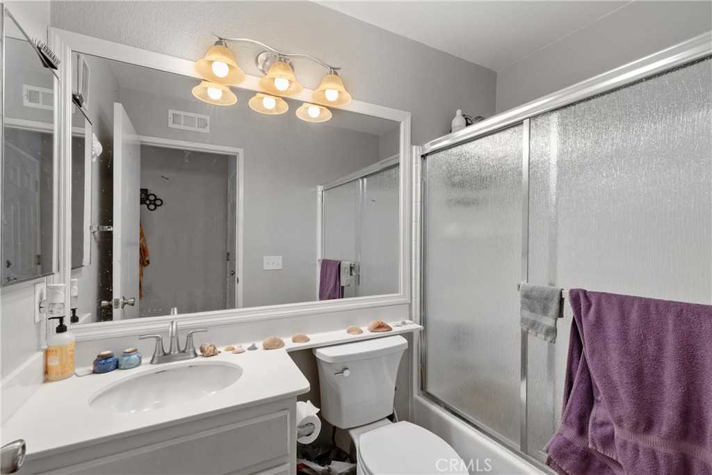 43545 Corte Logrono Temecula, CA 92592 - Photo 26 of 49 a bathroom with a sink a toilet and a mirror