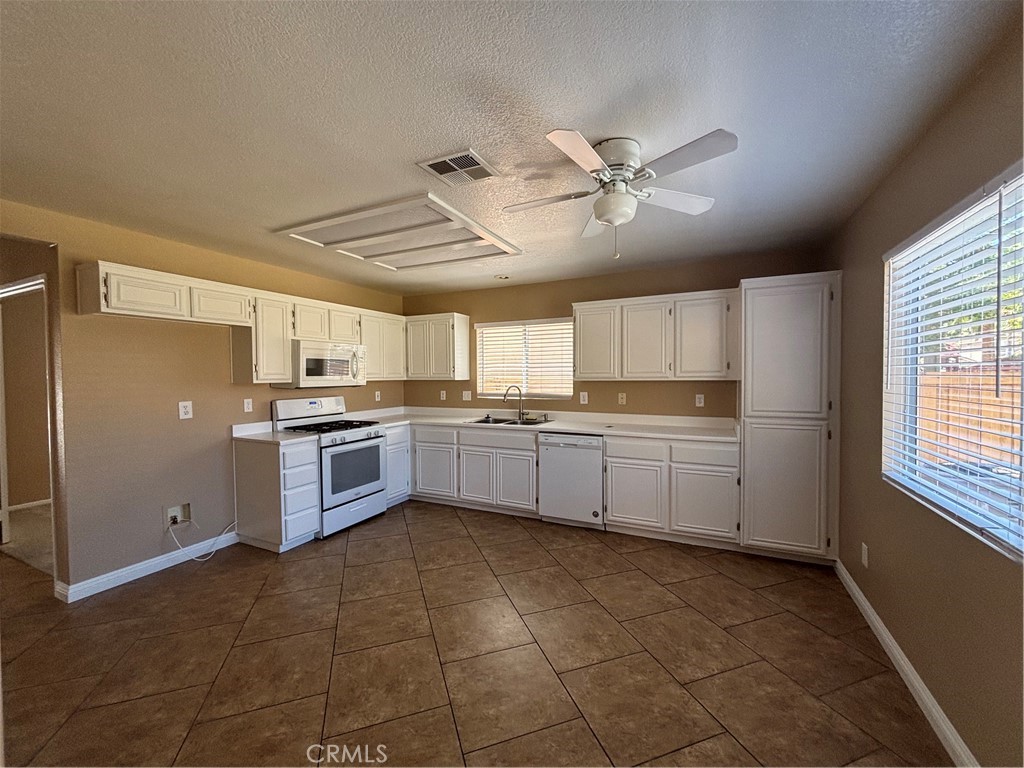 43545 Corte Logrono Temecula, CA 92592 - Photo 7 of 49 a kitchen with a stove a sink and a refrigerator