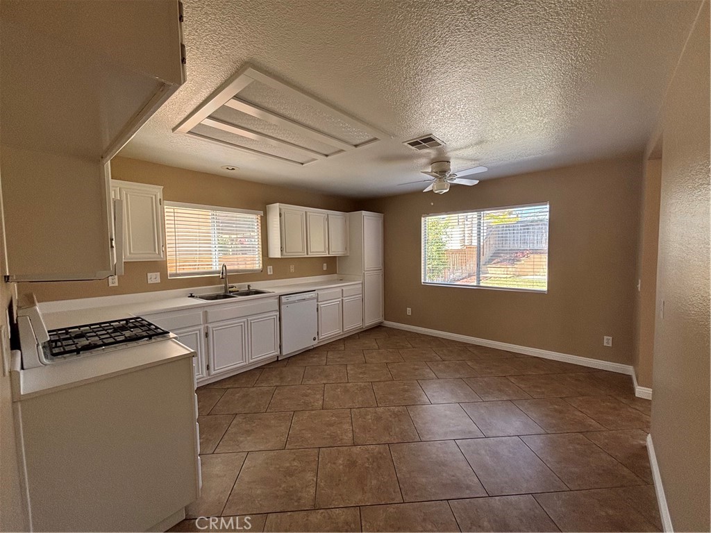43545 Corte Logrono Temecula, CA 92592 - Photo 8 of 49 a kitchen with stainless steel appliances granite countertop a stove a sink and a refrigerator