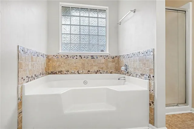 a bathroom with bathtub and window