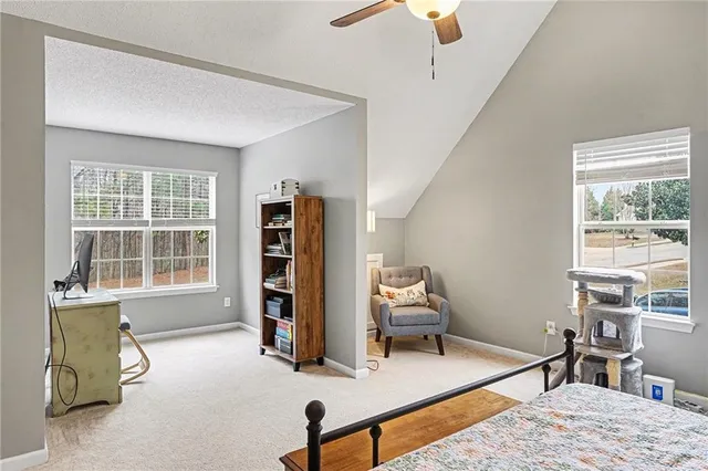 a bedroom with furniture and a window