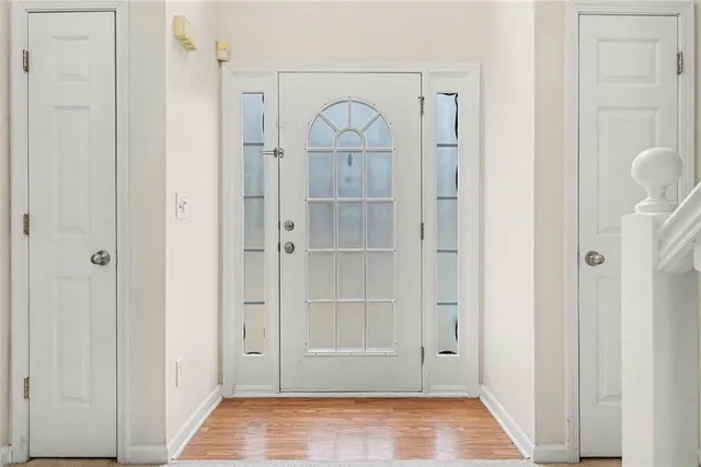 a view of an entryway with wooden floor