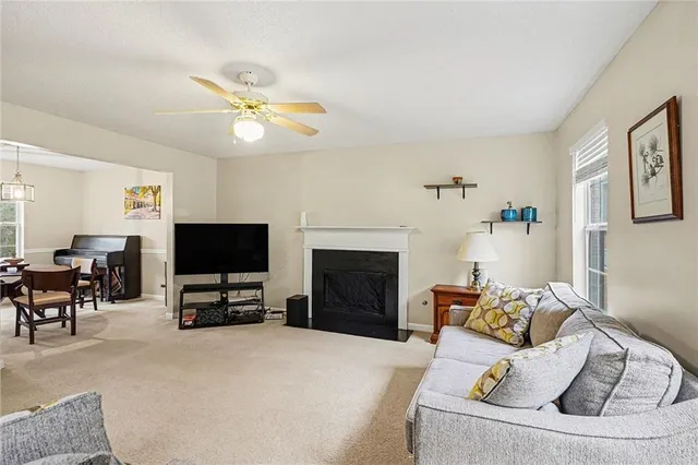 a living room with furniture a fireplace and a flat screen tv