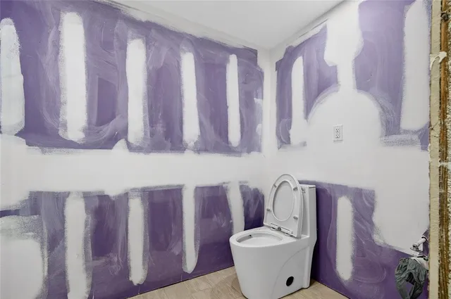 a view of an empty room with a ceiling fan and window