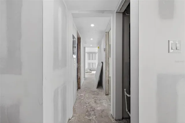 a view of a room with gym equipment and windows