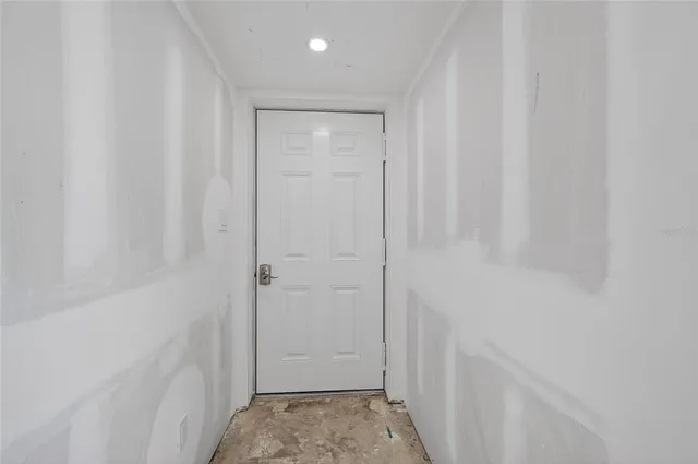 a view of a room with gym equipment and large windows