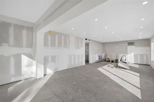 a view of a room with gym equipment and windows