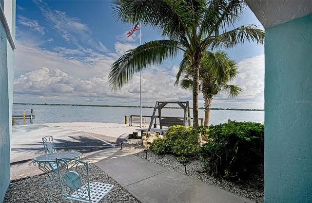 a view of a backyard with a garden and furniture