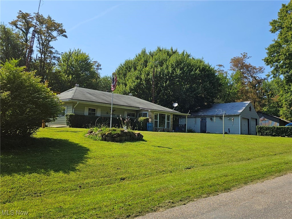 91510 Amos Road Scio, OH 43988 - Photo 2 of 12 view of house with a garage and a lawn