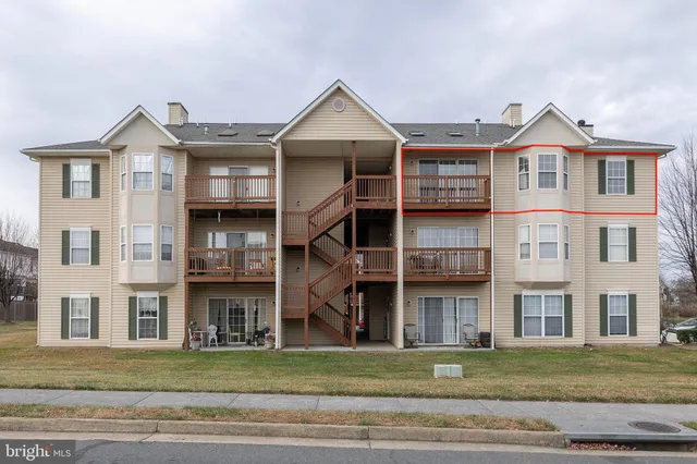 a front view of a residential apartment building with a yard