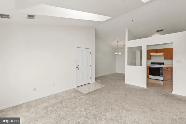 a view of a kitchen with refrigerator and kitchen