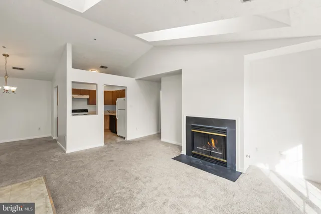 a view of an empty room with a fireplace