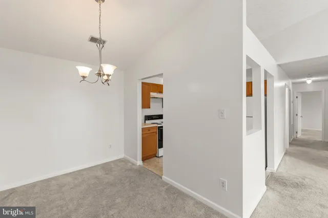a view of a hallway with a chandelier